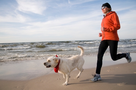 woman-running-with-dog-ashx